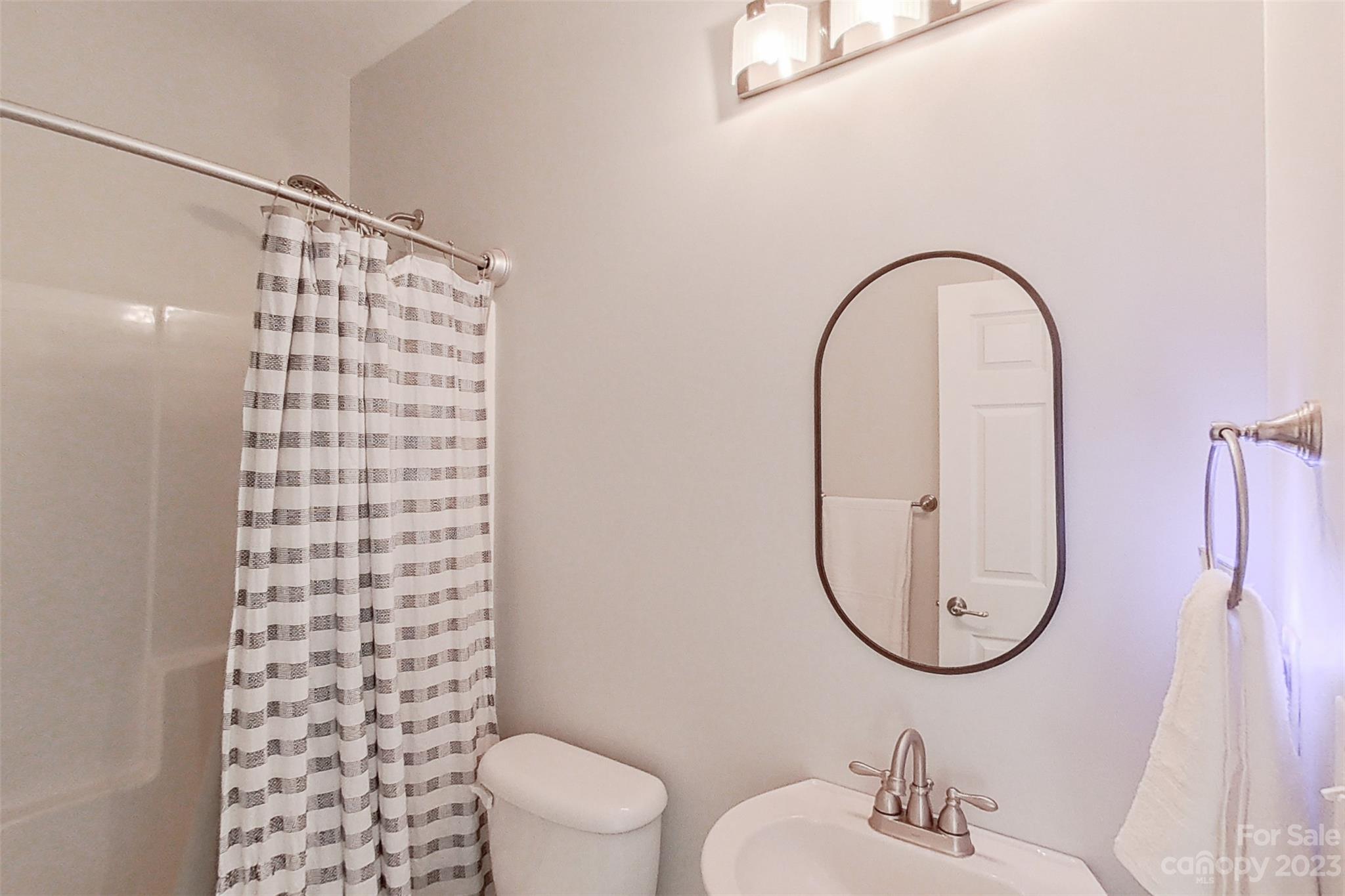 345 Rash Road Olin, NC 28660 - Photo 25 of 39 a bathroom with a sink a toilet and a mirror