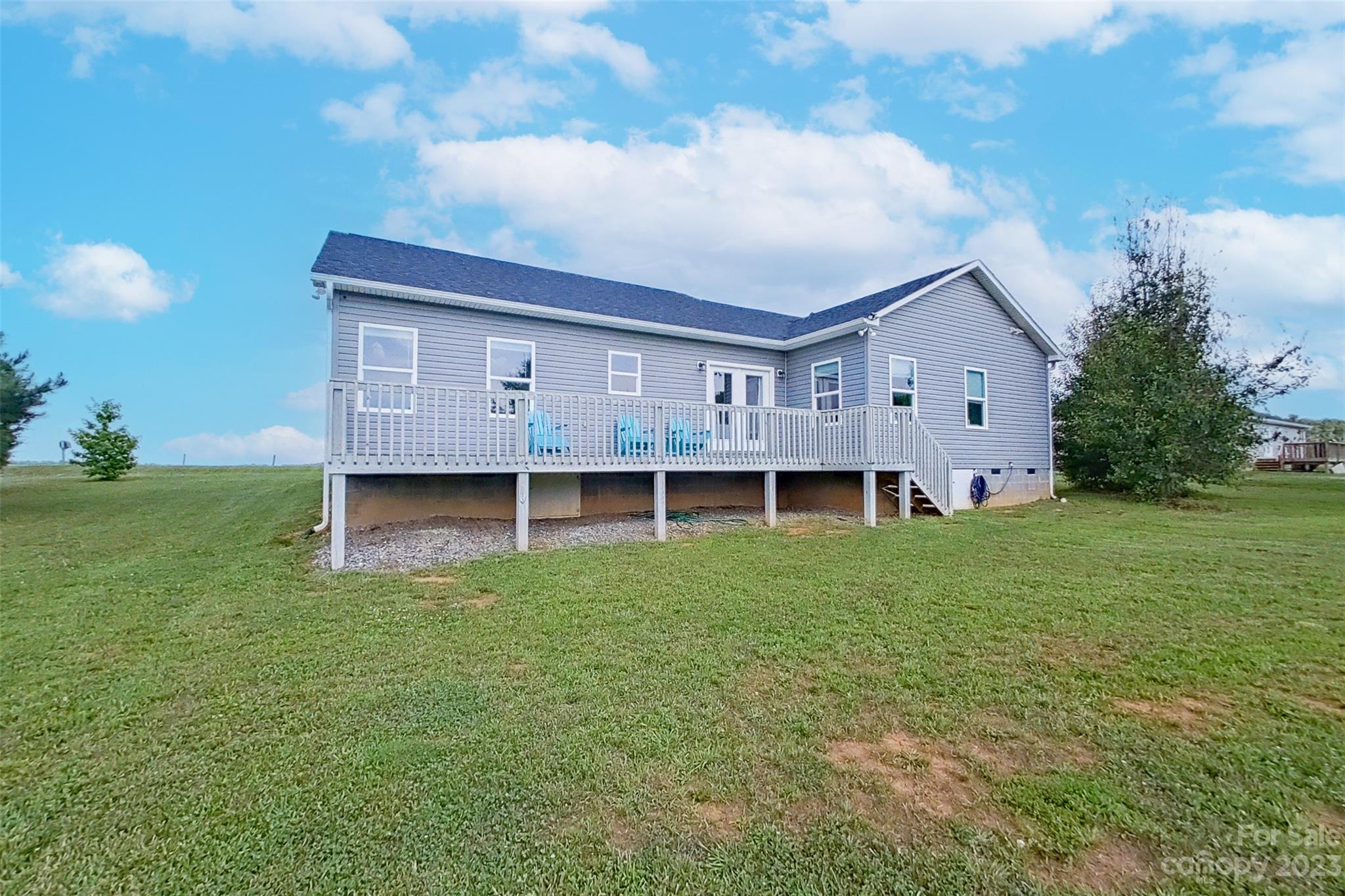 345 Rash Road Olin, NC 28660 - Photo 31 of 39 a view of a house with a backyard