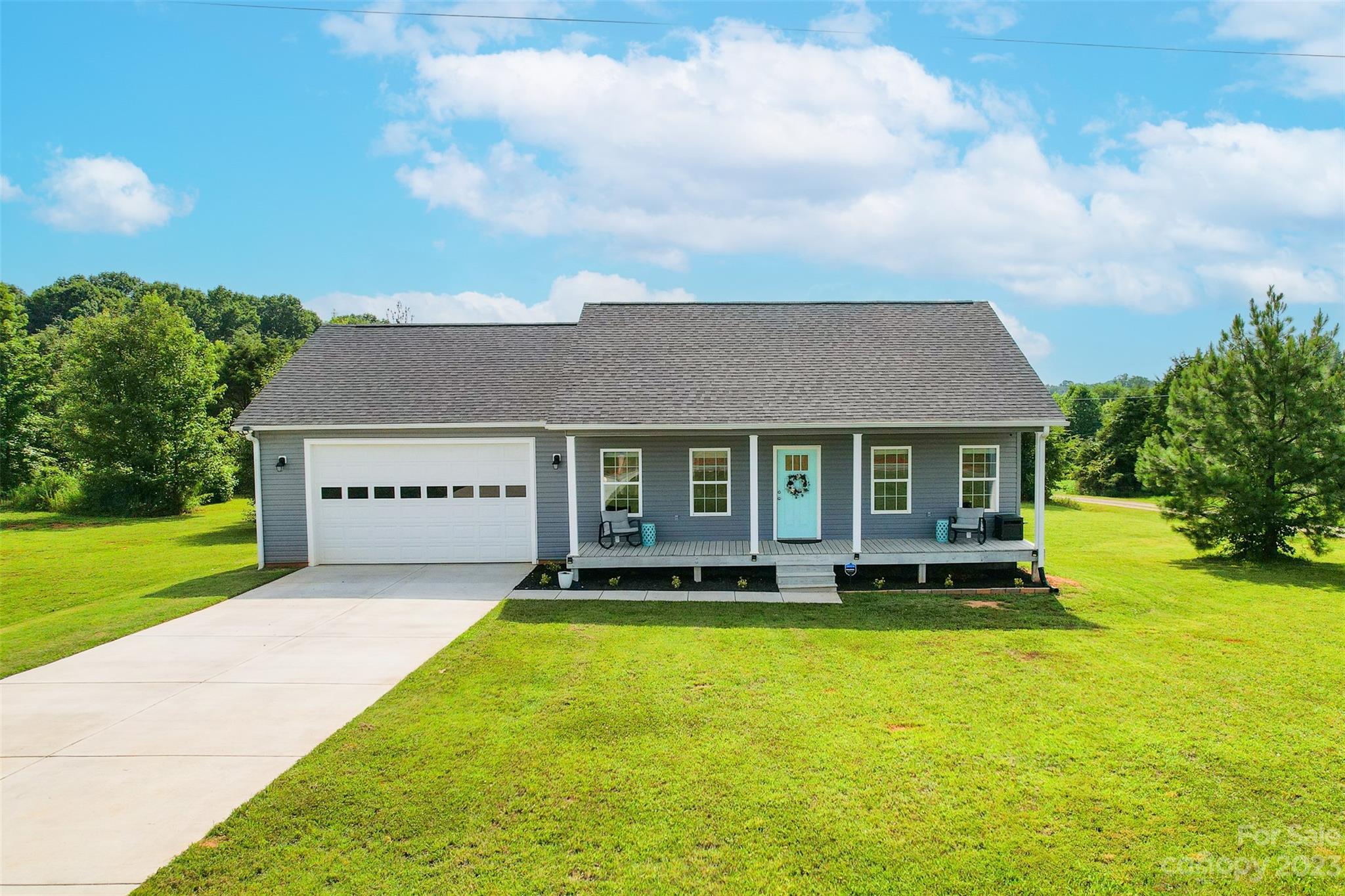 345 Rash Road Olin, NC 28660 - Photo 35 of 39 a front view of a house with yard and green space