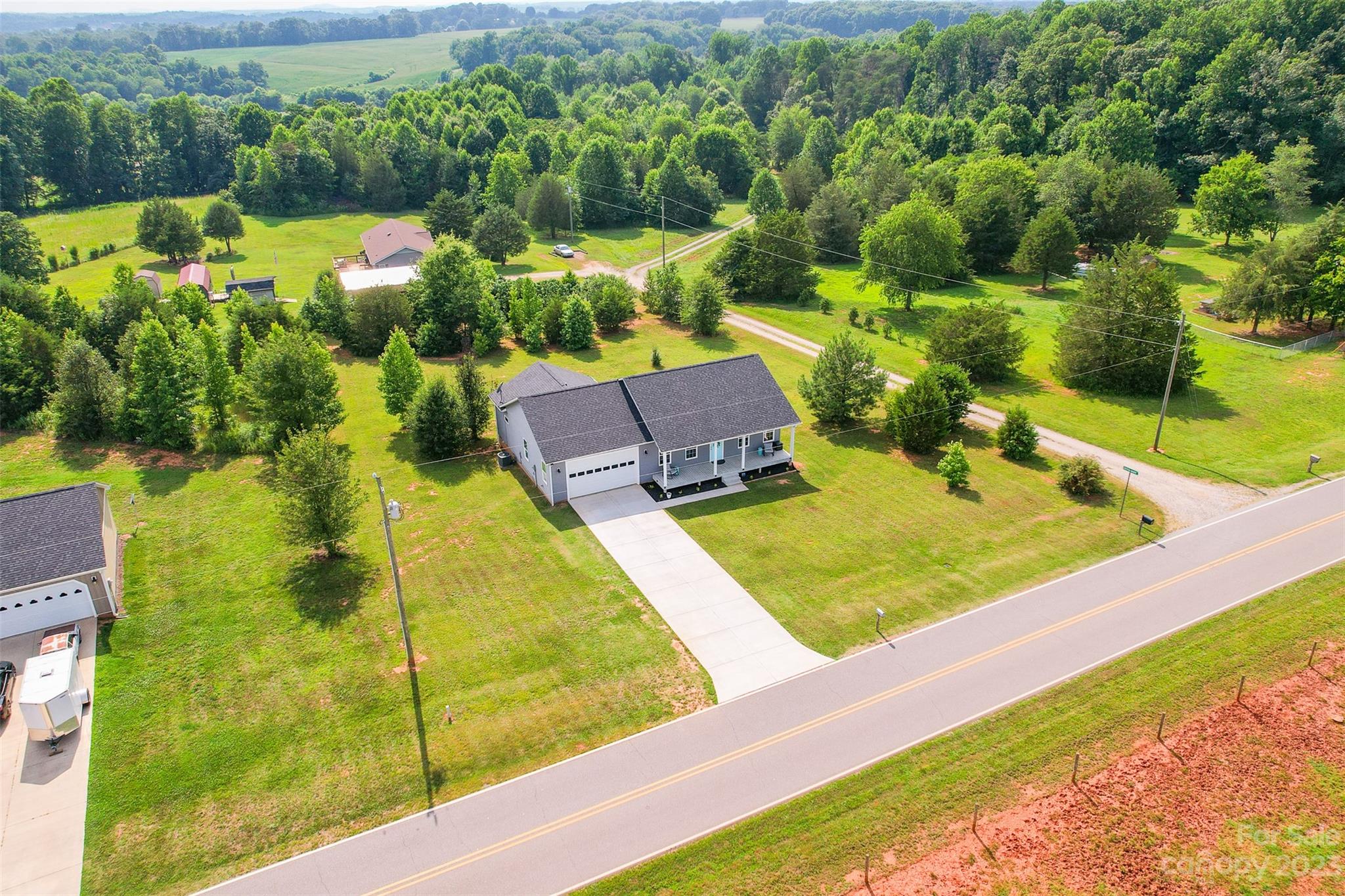 345 Rash Road Olin, NC 28660 - Photo 38 of 39 a view of a swimming pool with a yard