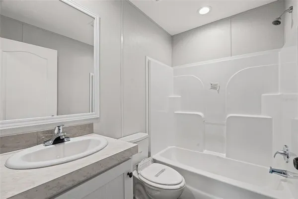 a bathroom with a sink a toilet and bathtub