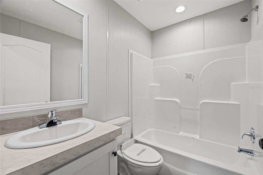 8432 Sweden Boulevard Punta Gorda, FL 33982 - Photo 16 of 23 a bathroom with a sink a toilet and bathtub