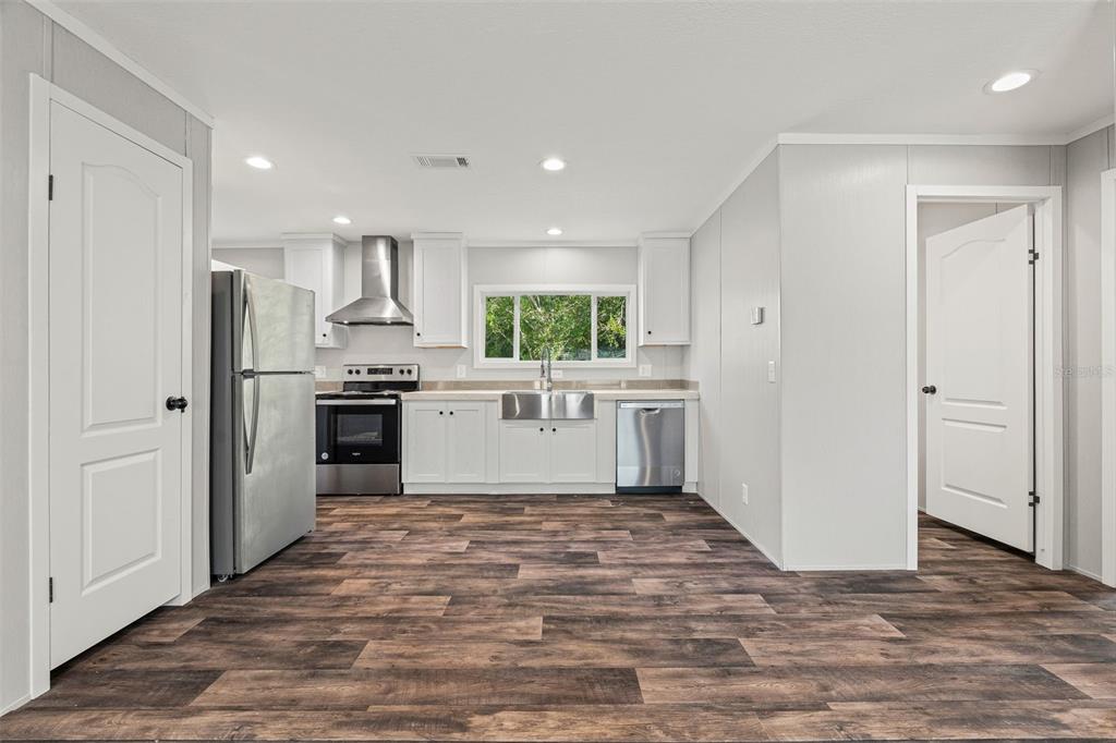 8432 Sweden Boulevard Punta Gorda, FL 33982 - Photo 7 of 23 a view of a kitchen with a sink a refrigerator and window