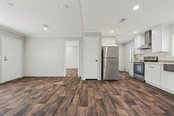 a kitchen with stainless steel appliances granite countertop a refrigerator and a stove top oven