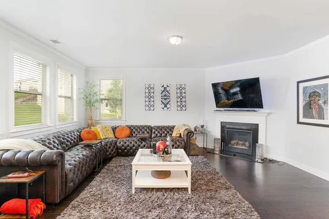a living room with furniture fireplace and flat screen tv