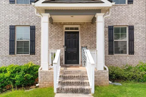 a front view of a house with stairs