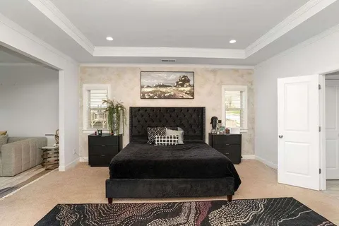 a bedroom with a bed and a couch