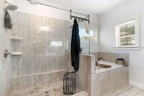 a bathroom with a tub and shower