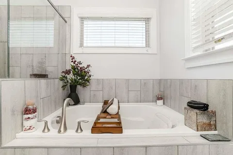 a bathroom with a bathtub and a window