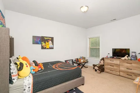 a bedroom with furniture and a flat screen tv