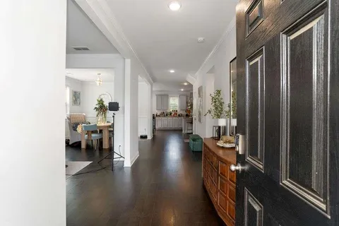a hallway with a view of living room with furniture