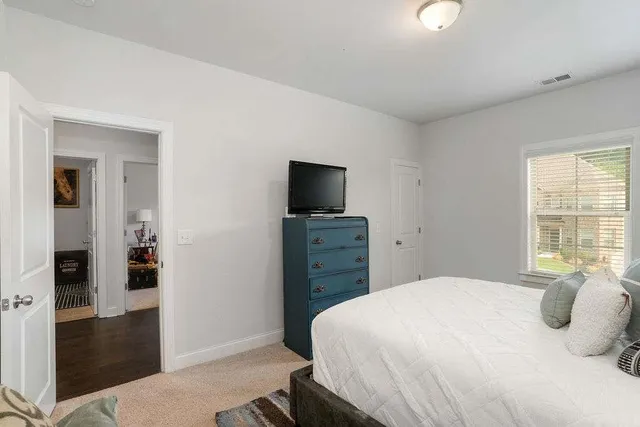 a bedroom with a balcony a bed and a television