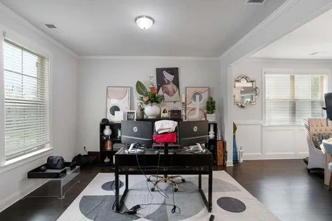 a view of a workspace with furniture and a window