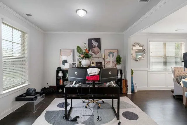 a view of a workspace with furniture and a window