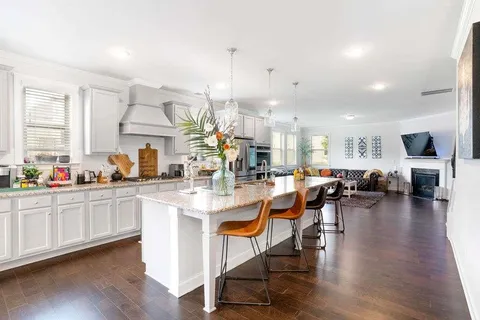 a very nice looking living room with dining room and wooden floor