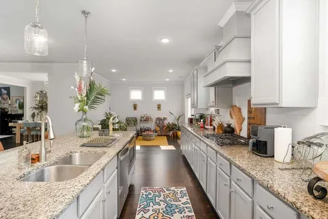 a kitchen with counter top space a sink and cabinets
