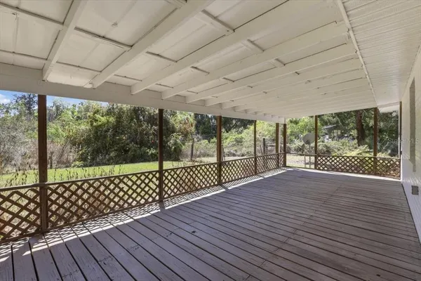a view of porch with wooden floor