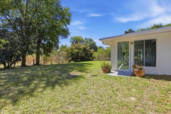 a view of a house with backyard porch and garden