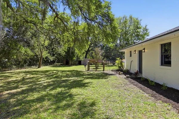 a view of a backyard with large trees