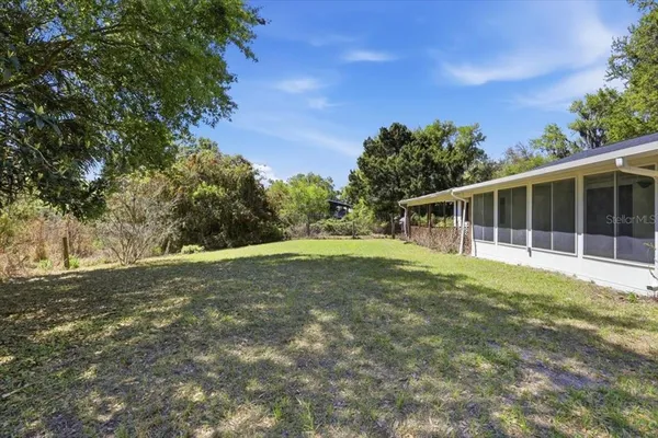 a view of a house with a backyard