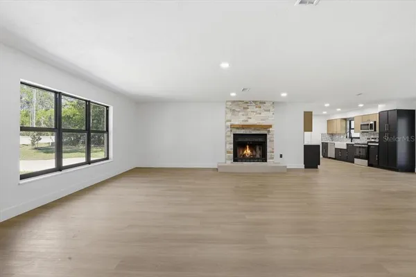 an empty room with furniture and a fireplace