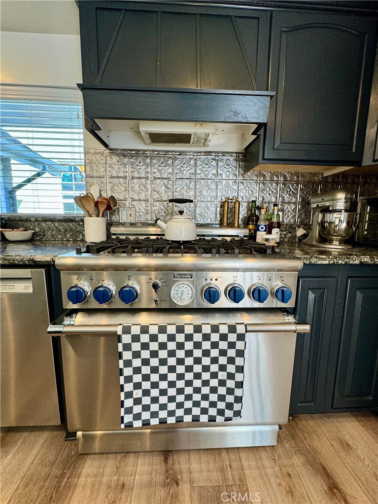 437 Cypress Drive, Unit B Laguna Beach, CA 92651 - Photo 11 of 20 a kitchen with a stove and wooden cabinets