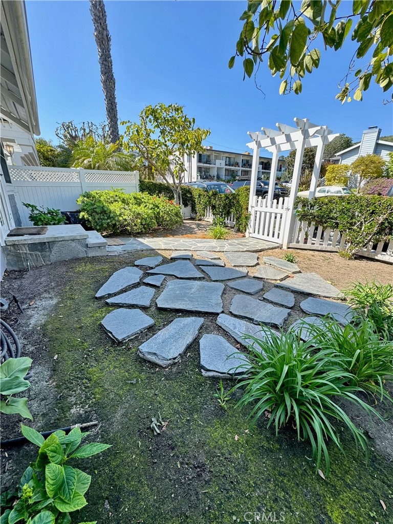 437 Cypress Drive, Unit B Laguna Beach, CA 92651 - Photo 3 of 20 a view of a house with backyard and sitting area