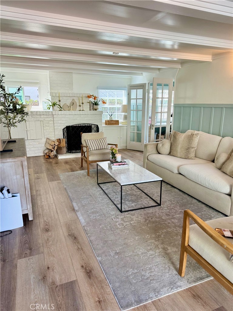 437 Cypress Drive, Unit B Laguna Beach, CA 92651 - Photo 4 of 20 a living room with furniture and a fireplace