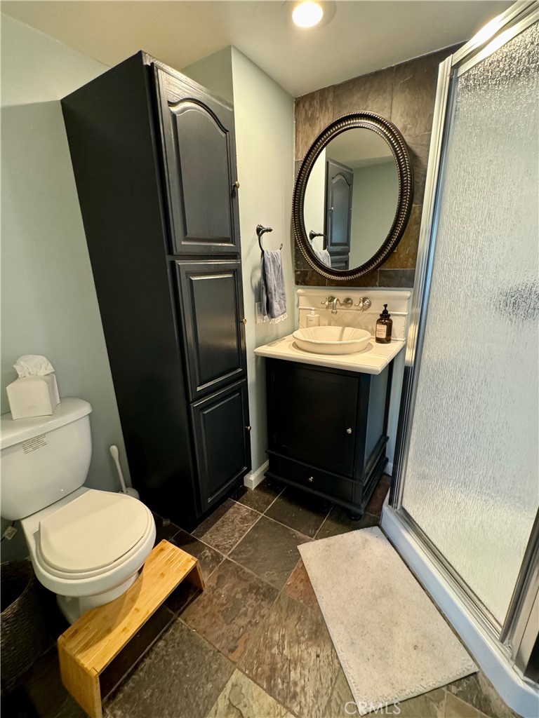 437 Cypress Drive, Unit B Laguna Beach, CA 92651 - Photo 8 of 20 a bathroom with a toilet mirror and vanity
