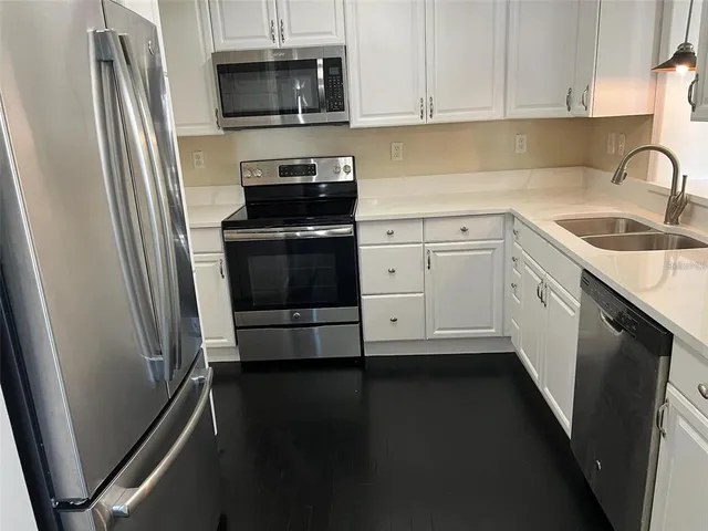a kitchen with a sink and a stove top oven