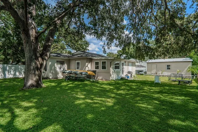 a front view of a house with a garden and yard