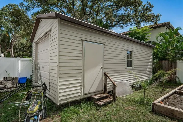 a view of a small house and a yard