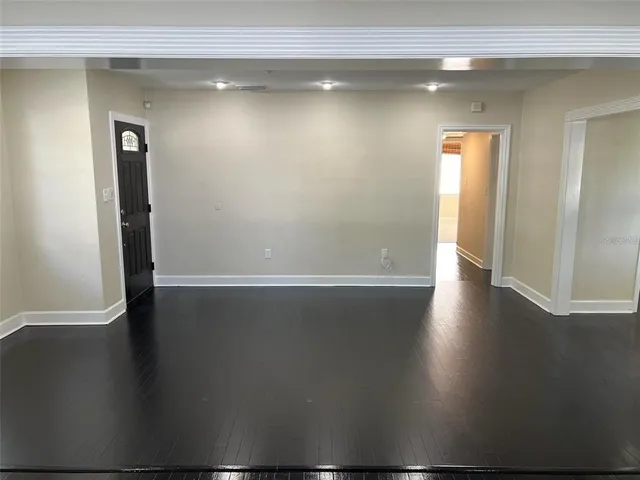 a view of a room with wooden floor
