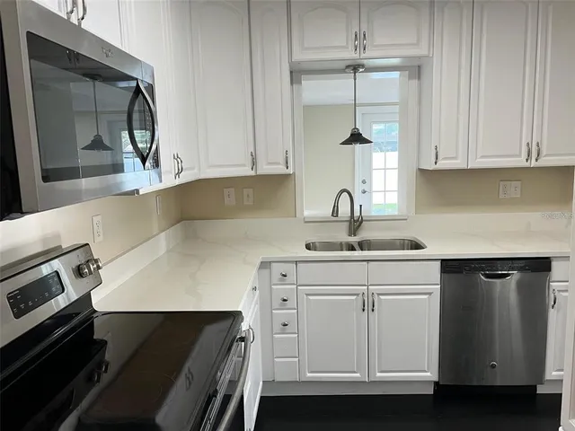 a kitchen with white cabinets and a stove
