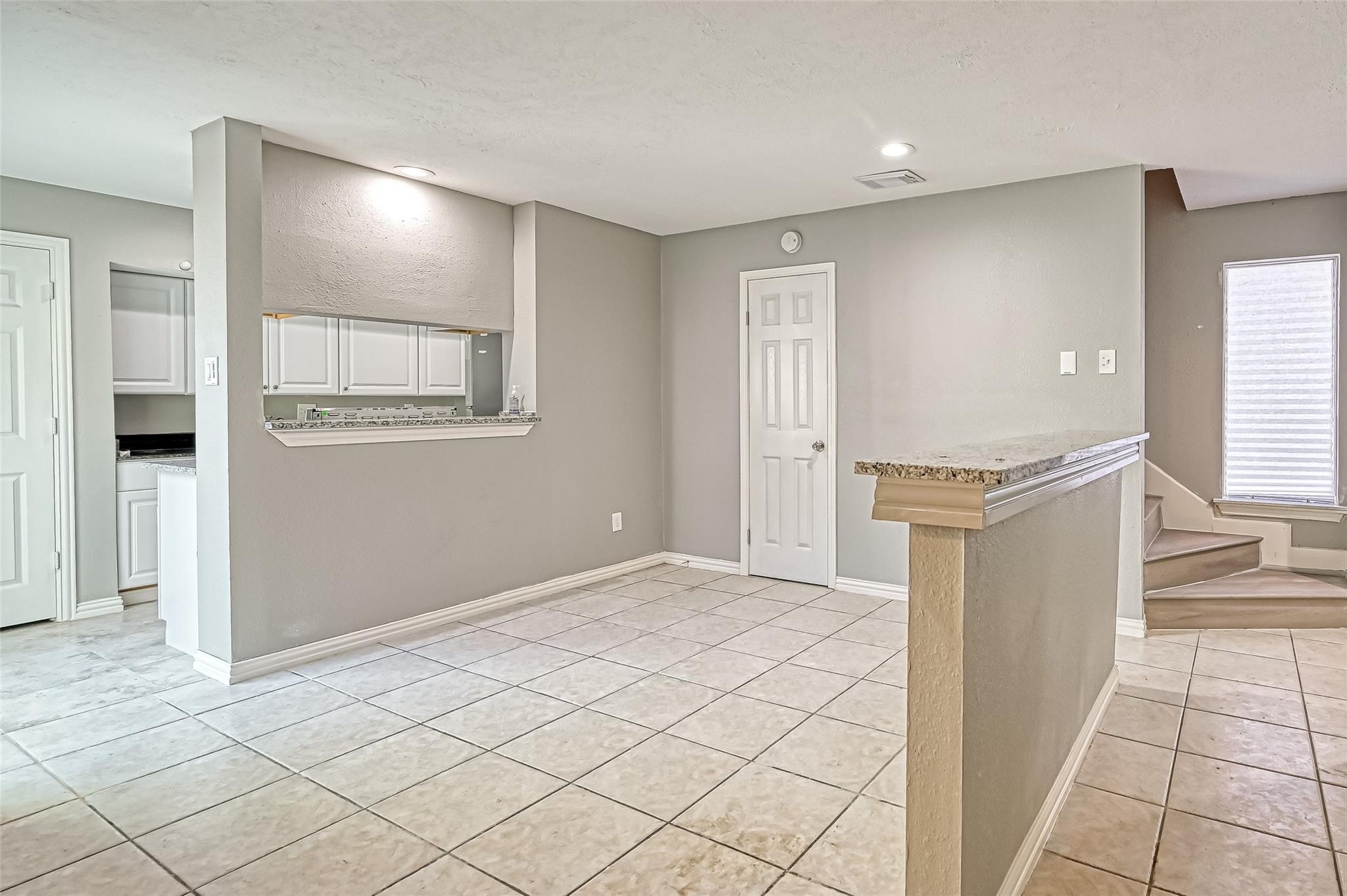 10252 Cottage Field Road Houston, TX 77041 - Photo 3 of 18 a view of a kitchen with an empty space and a window