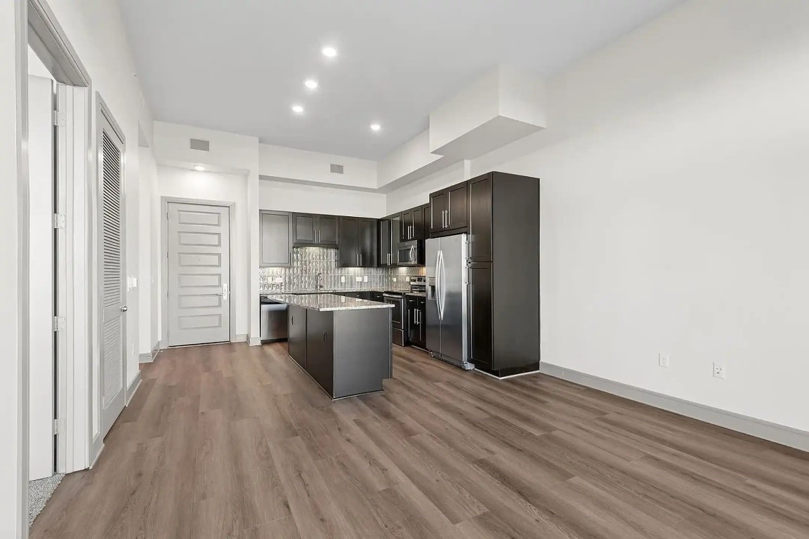 2724 Kipling Street, Unit 308 Houston, TX 77098 - Photo 25 of 29 a view of a kitchen with wooden floor and electronic appliances