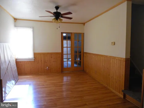 a view of empty room with wooden floor