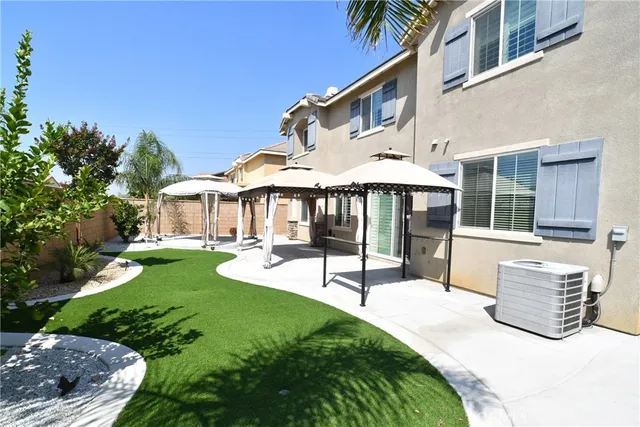 a view of a house with backyard porch and sitting area