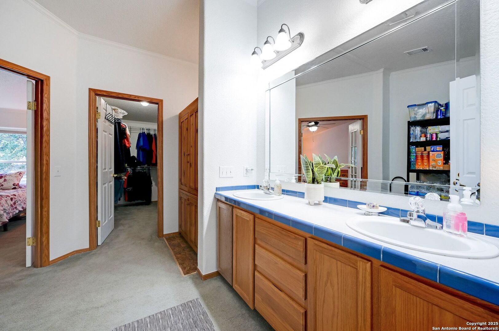 480 Rangeland Road Blanco, TX 78606 - Photo 13 of 26 a en suite bathroom with a double vanity sink and a mirror