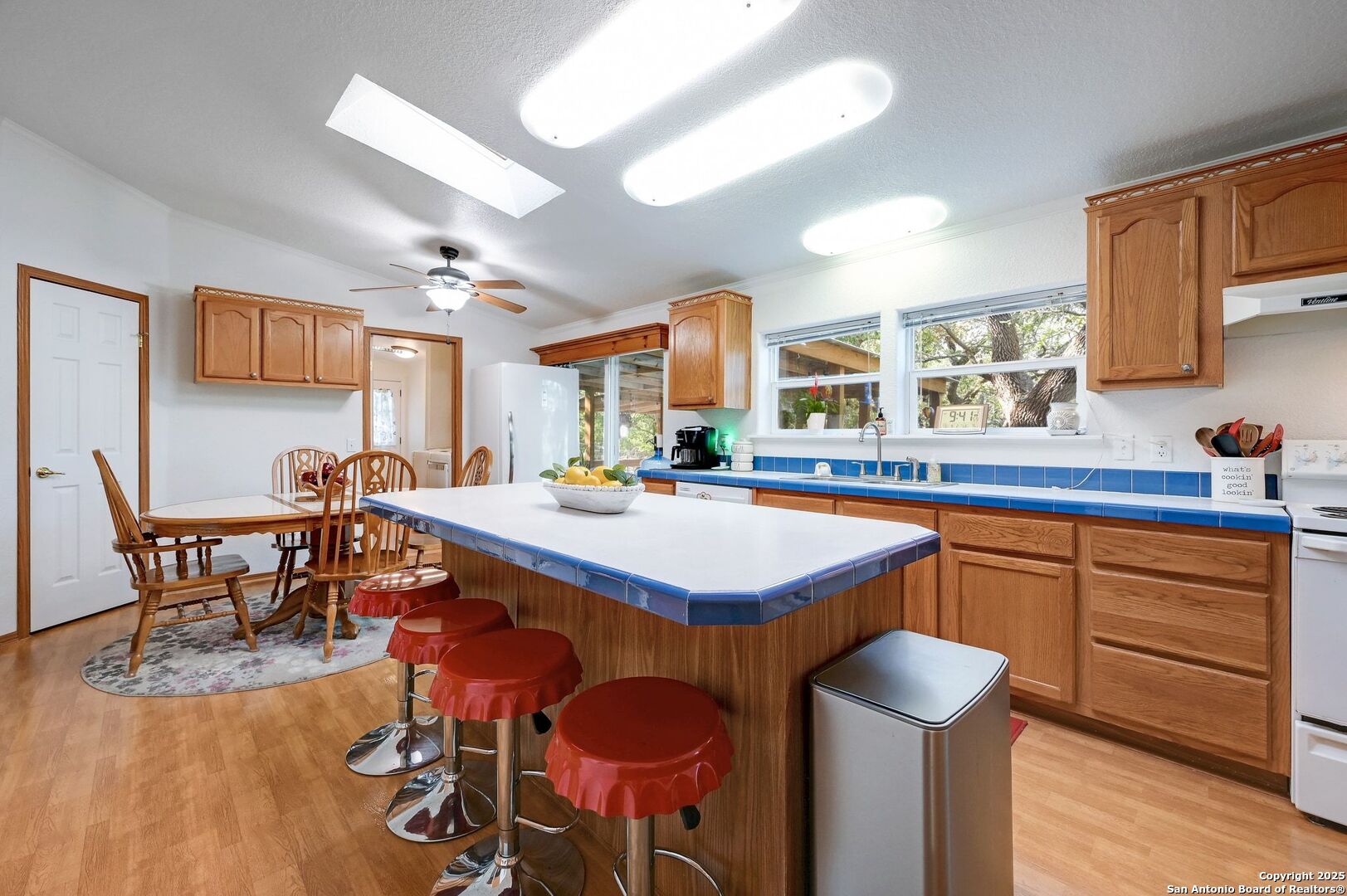 480 Rangeland Road Blanco, TX 78606 - Photo 14 of 26 a kitchen with a dining table chairs sink and granite counter top