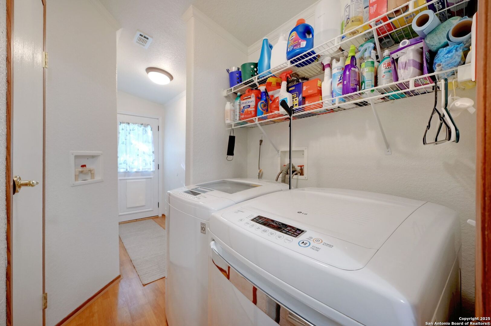 480 Rangeland Road Blanco, TX 78606 - Photo 16 of 26 a utility room with dryer washer and a view of living room