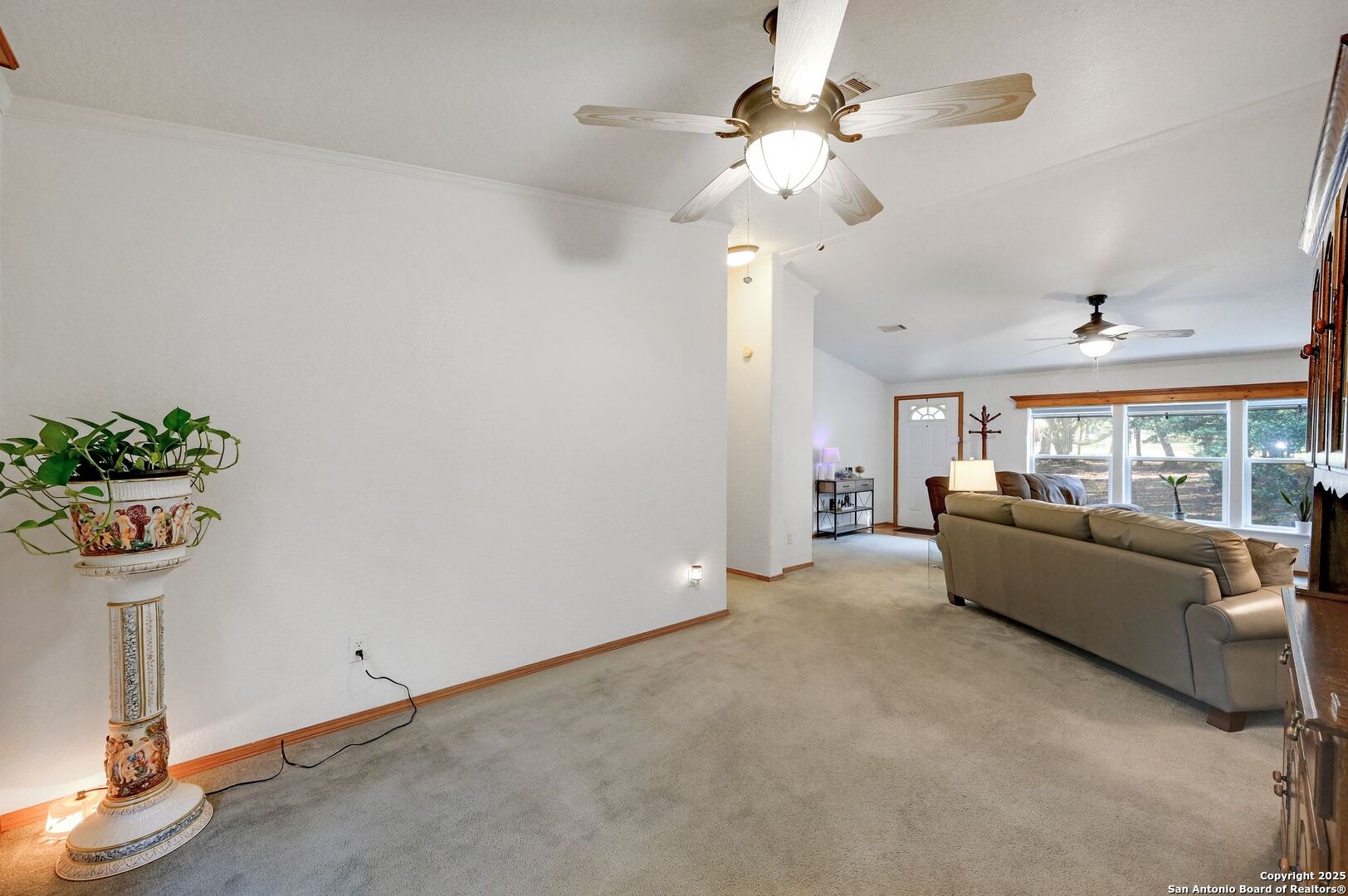 480 Rangeland Road Blanco, TX 78606 - Photo 6 of 26 a living room with furniture and a chandelier