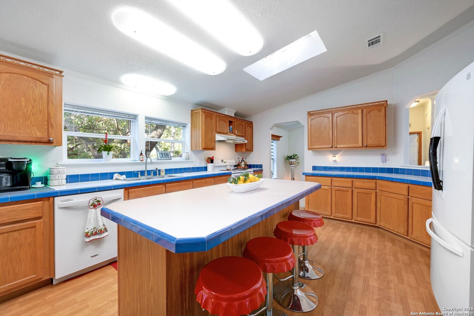 480 Rangeland Road Blanco, TX 78606 - Photo 8 of 26 a kitchen with stainless steel appliances granite countertop a sink dishwasher and a stove with wooden floor