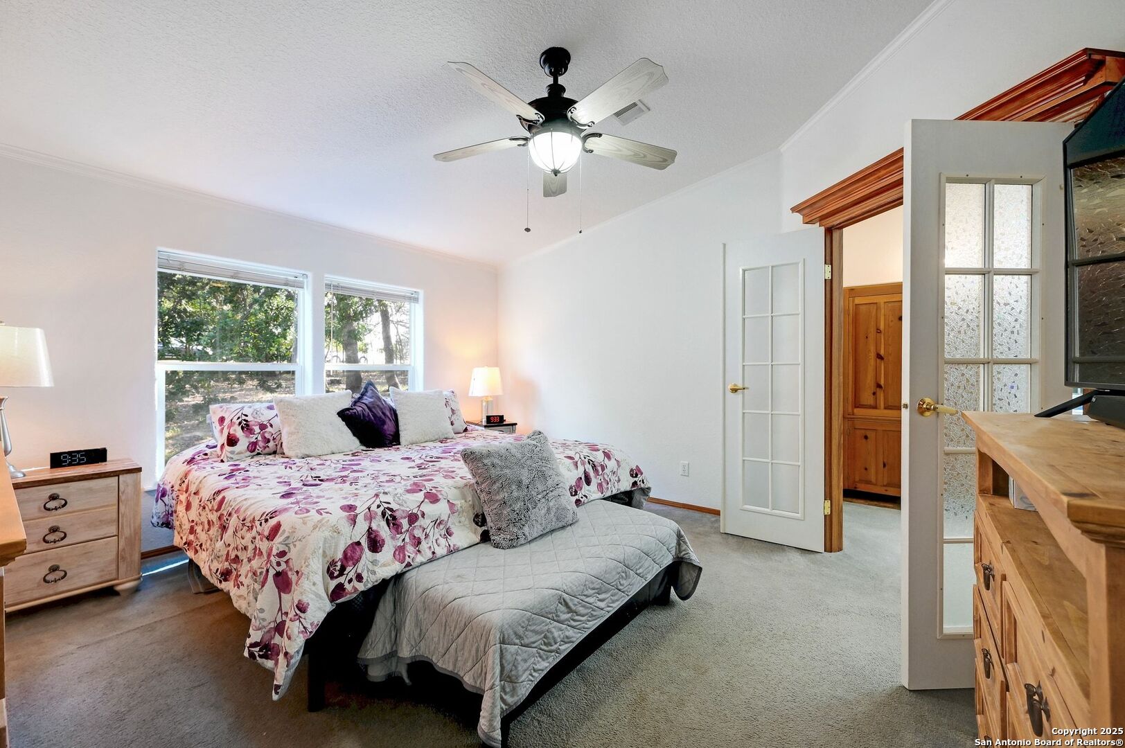 480 Rangeland Road Blanco, TX 78606 - Photo 10 of 26 a bed room with a bed and a chandelier