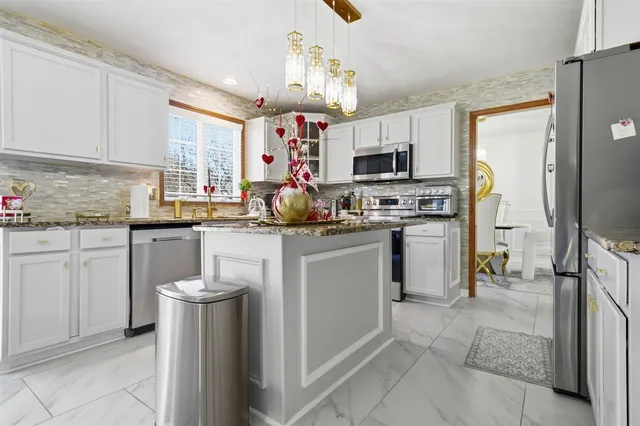 a kitchen with a sink stove and refrigerator