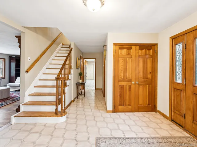 a view of entryway with wooden floor and stairs