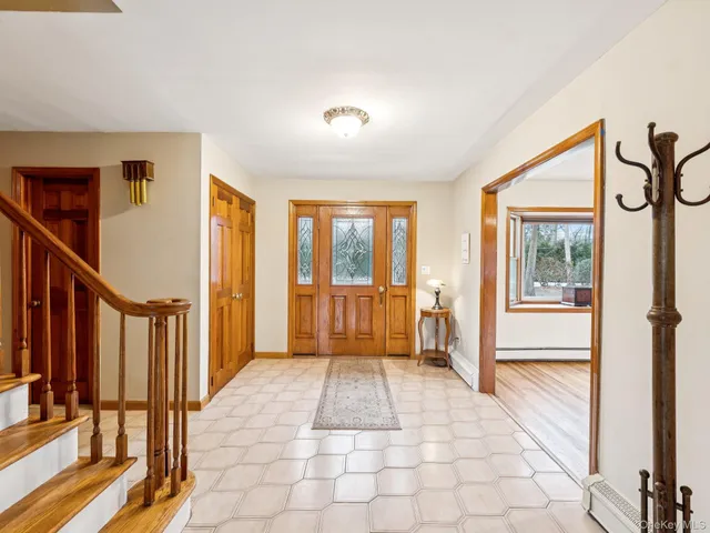 a view of a hallway with wooden floor and windows