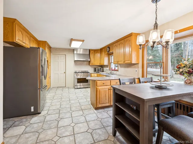 a kitchen with a sink a stove a refrigerator and cabinets