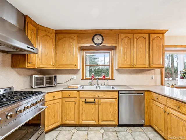 a kitchen with stainless steel appliances granite countertop a stove and a sink