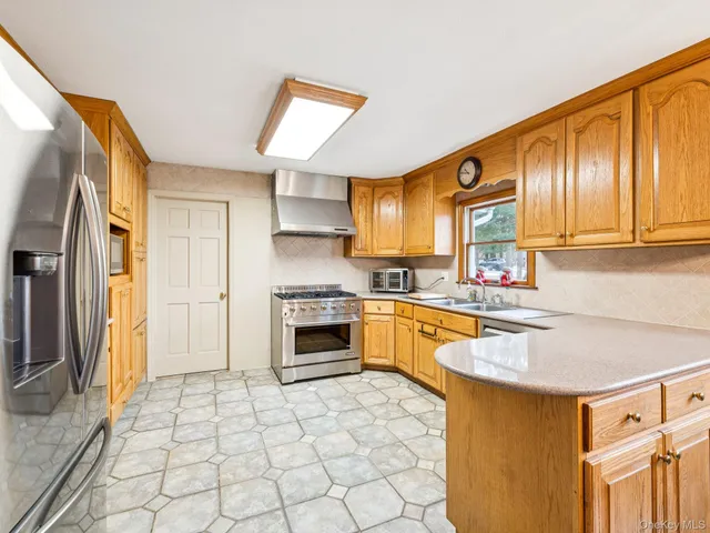 a kitchen with a sink a stove top oven and appliances